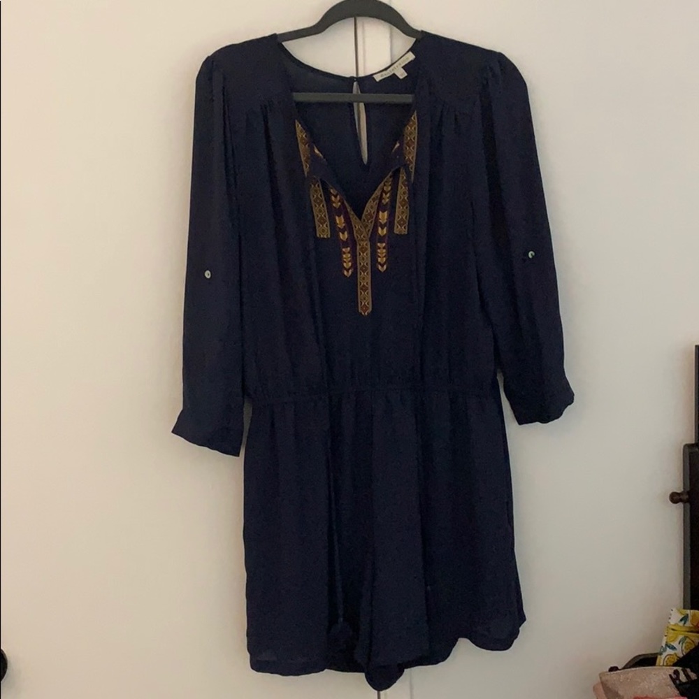 Blue romper with a yellow type pattern